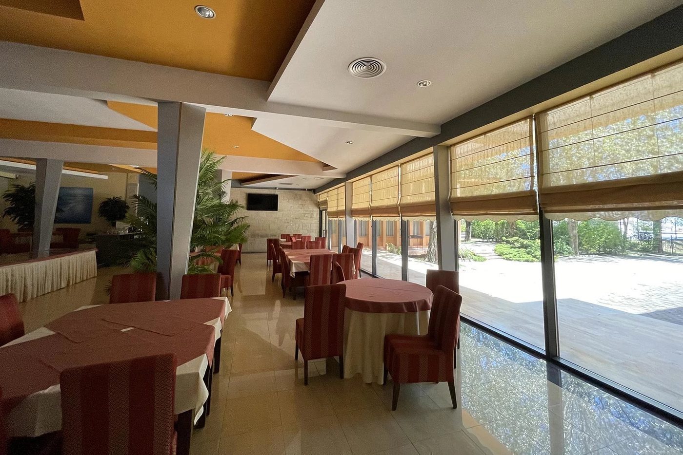 Sala restaurantului Hotel Palas, cu ferestre spre grădină